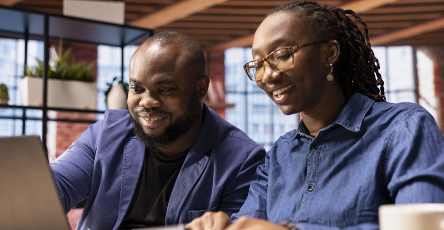 African american man and woman review their earnings and revenue reports